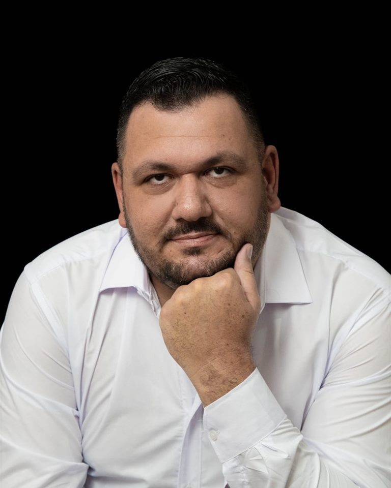 Fernando Ribeiro, contador em Divinópolis MG, em retrato de estúdio com fundo escuro.